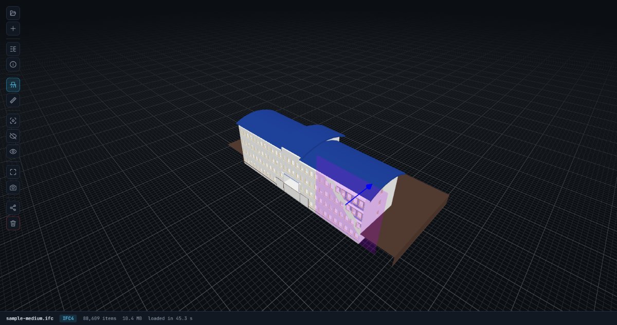 IFC model sliced by a section plane in the browser viewer, with the draggable arrow gizmo visible